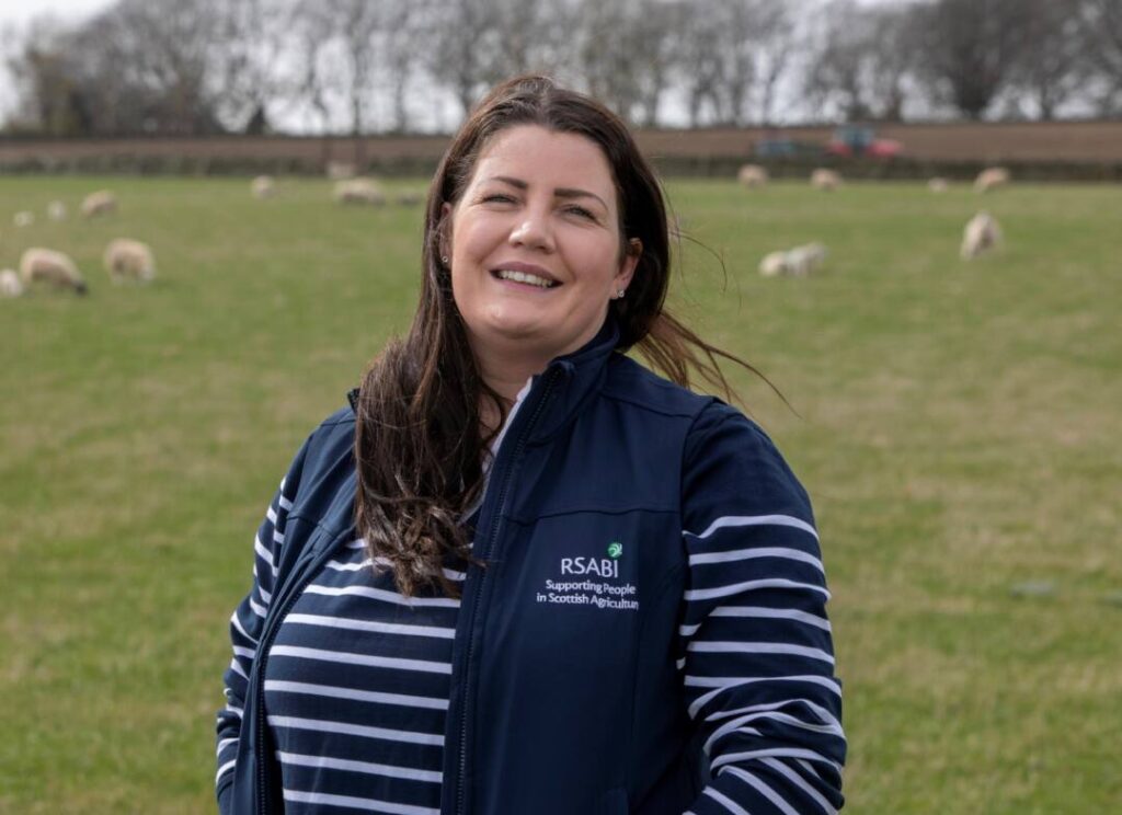 Laura with sheep outside